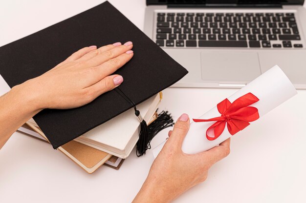 Graduation diploma certificate and graduation hat