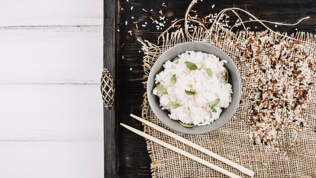 Grains and chopsticks near boiled rice