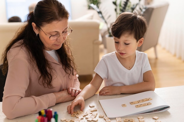 Grandchild doing homework with grandmother