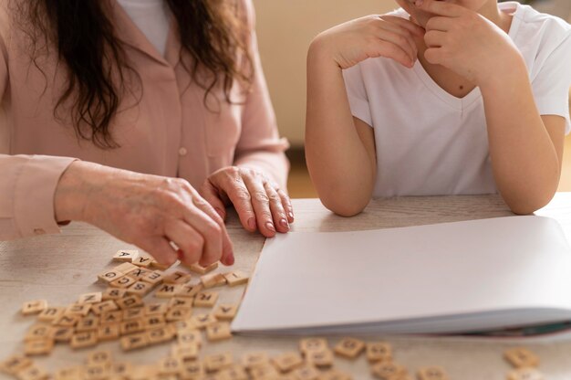 Grandchild doing homework with grandmother