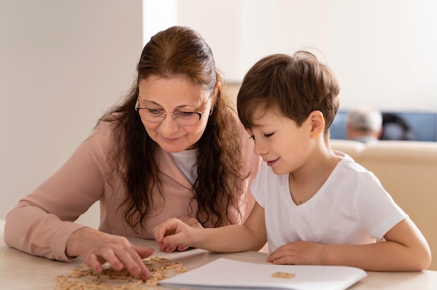 Grandchild doing homework with grandmother