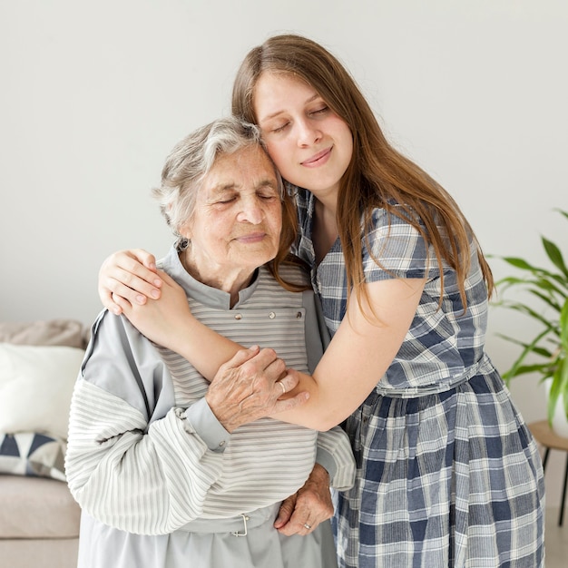 Бесплатное фото Внучка обнимает бабушку с любовью