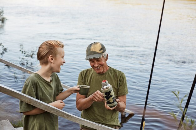 Grandfather and boy fishing together