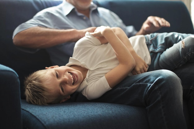 grandfather tickles his grandson