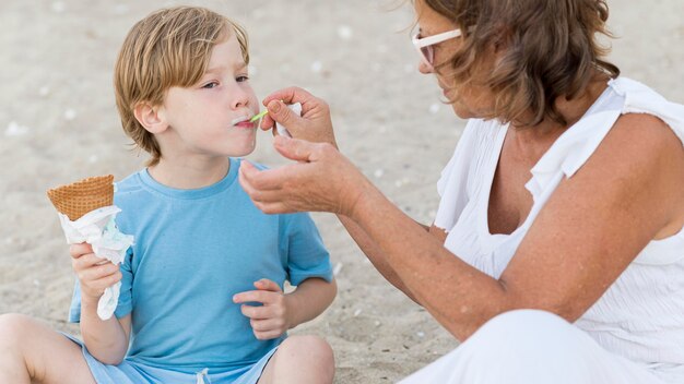 Grandma feeding boy with ice cream