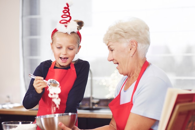 Grandma and girl making cookies together