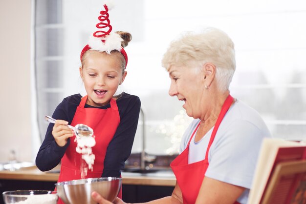 Grandma and girl making cookies together