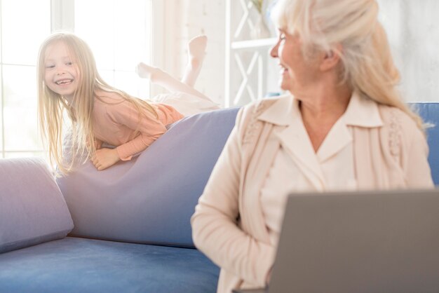 Grandma and girl together using laptop