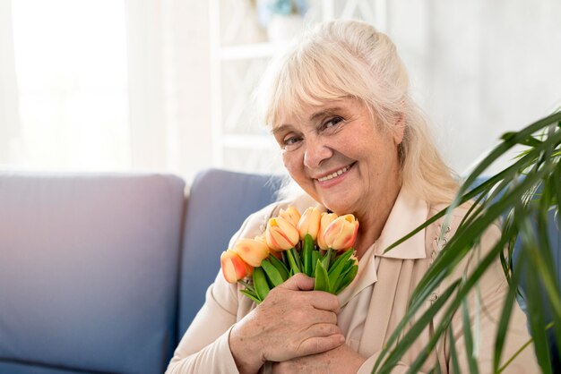 Grandmother on couch with flowers