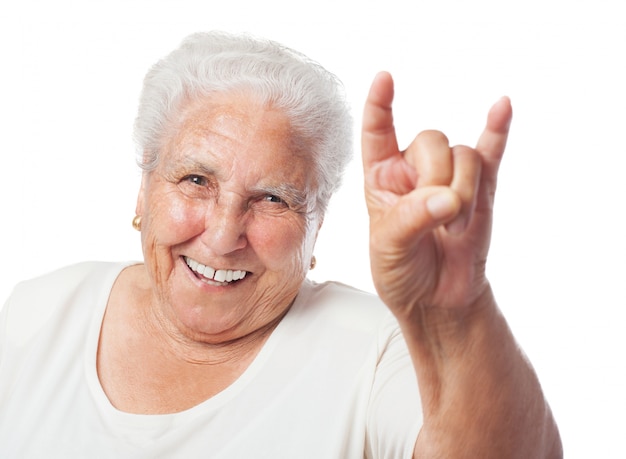 Free photo grandmother doing the horns