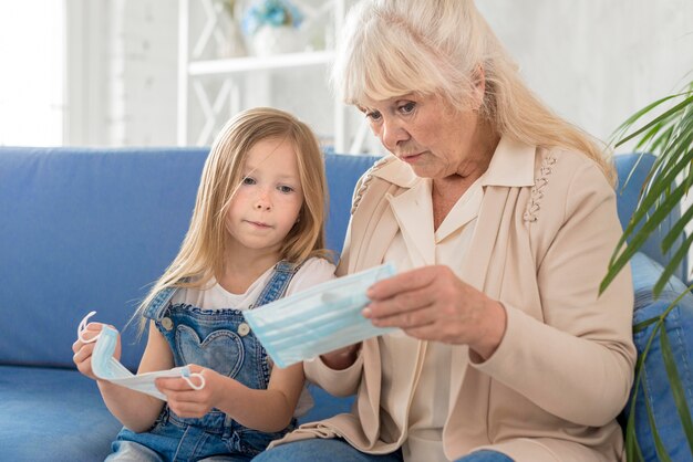 Grandmother and girl with mask