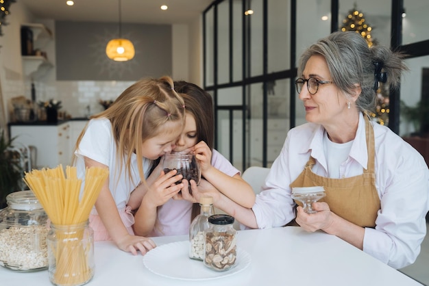 Grandmother and granddaughter are cooking on kitchen Grandmother shares experience