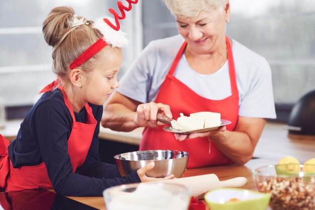 Grandmother and granddaughter cooking in the kitchen
