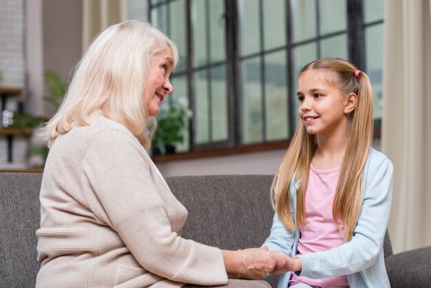 Grandmother and granddaughter holding hands