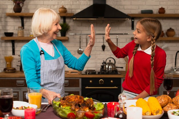 Grandmother and granddaughter playing in the kitchen