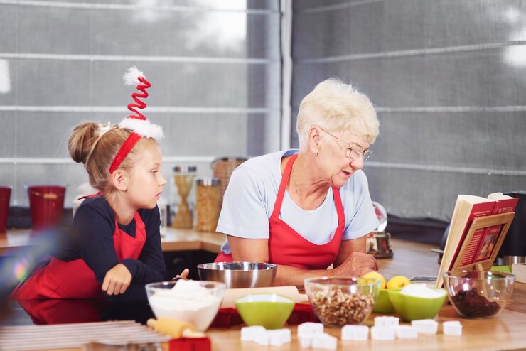 Free Photo grandmother and granddaughter preparing christmas cake