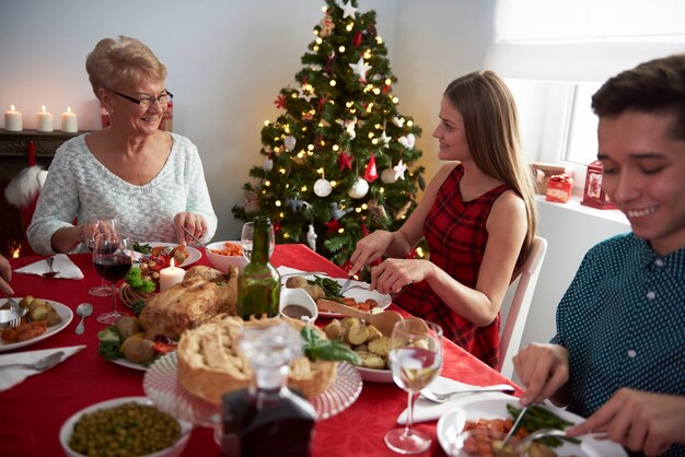 Grandmother and her grandchildren at Christmas table