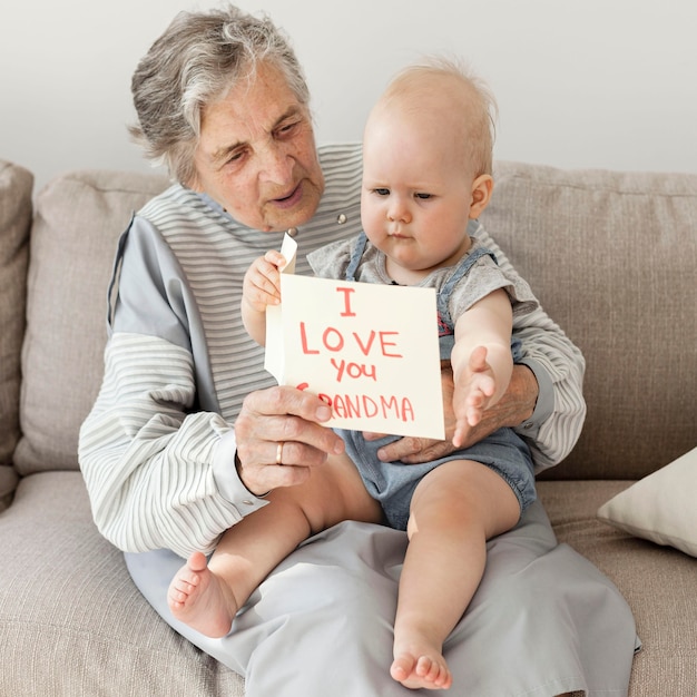 Grandmother holding grandchild at home