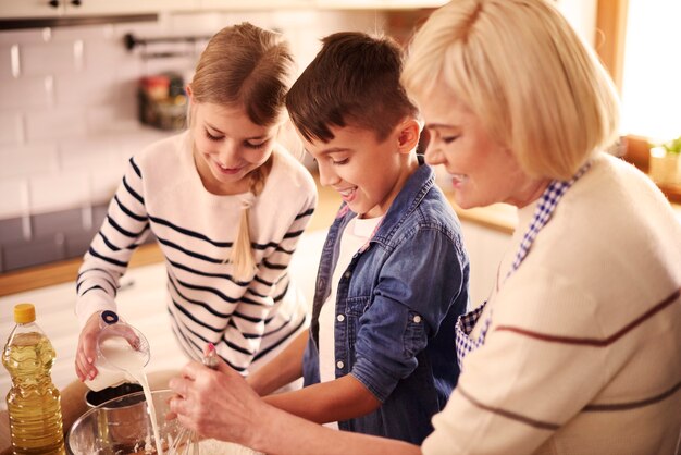 Grandmother and kids preparing something special