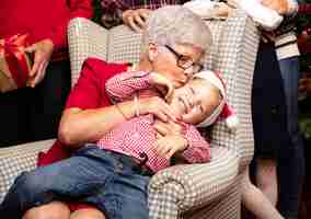 Free photo grandmother kissing his grandson on the head