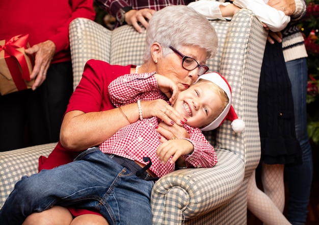 Grandmother kissing his grandson on the head