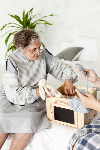 Grandmother looking at old toys at home