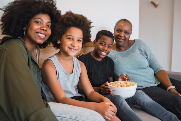 Grandmother, mother and children together at home.