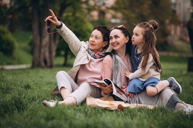 Grandmother mother daughter in park picnic