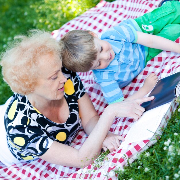 Grandmother reading book to her grandson