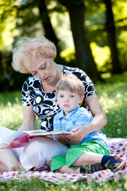 Grandmother reading the book to her grandson