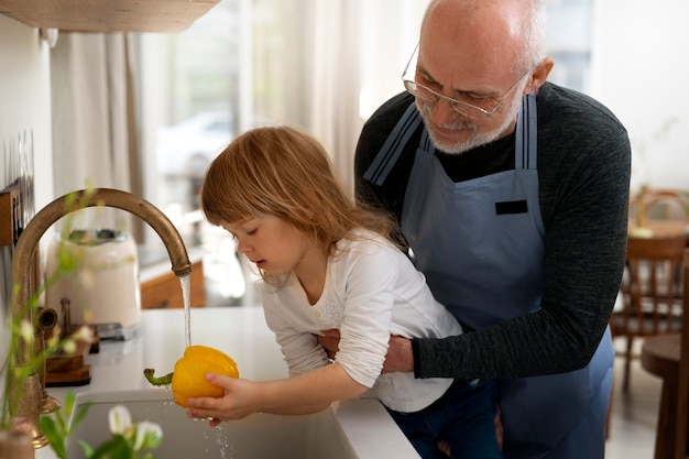 Free photo grandpa cooking together with grandkid