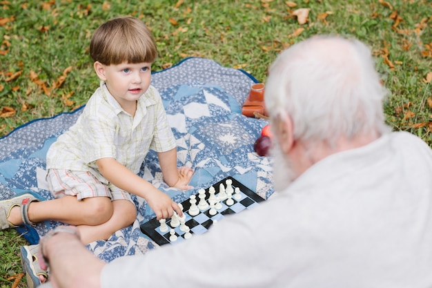 Grandpa and grandson playing chess