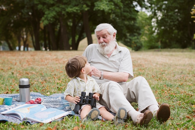Grandpa teaching grandson about binocular