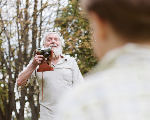 Grandpa telling grandson how to stay for photos