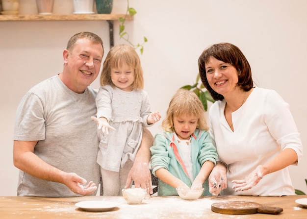 Free photo grandparents and granddaughters cooking