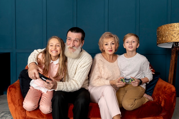 Free photo grandparents playing video games with their grandchildren