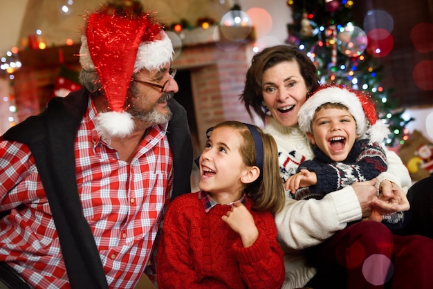 Grandparents playing with grandchildren in their living room