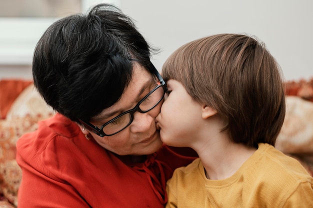 Free photo grandson kissing his grandmother