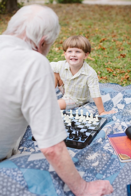 Granfather teaching grandson chess