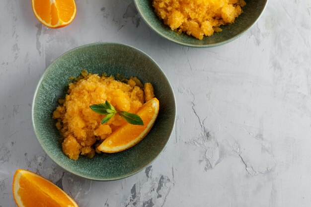 Granita dessert with orange still life top view