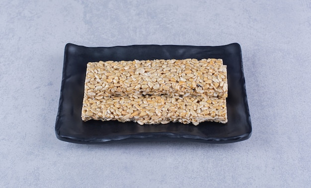 Free photo granola bars on a platter on the marble surface