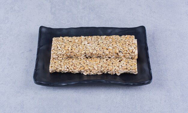Granola bars on a platter on the marble surface