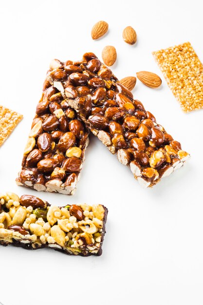 Granola; sesame seed and almonds bars on white background