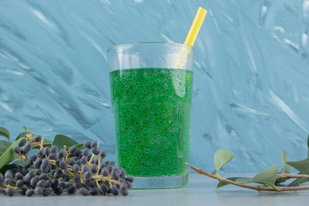 Grape and green juice on the blue background. High quality photo