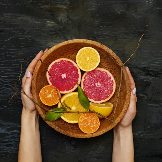 Grapefruit citrus fruit halves on wooden plate