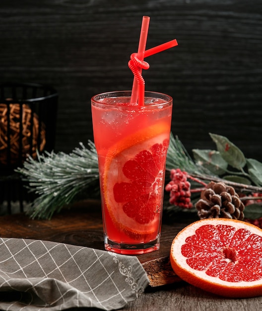 Grapefruit cocktail with ice on the table