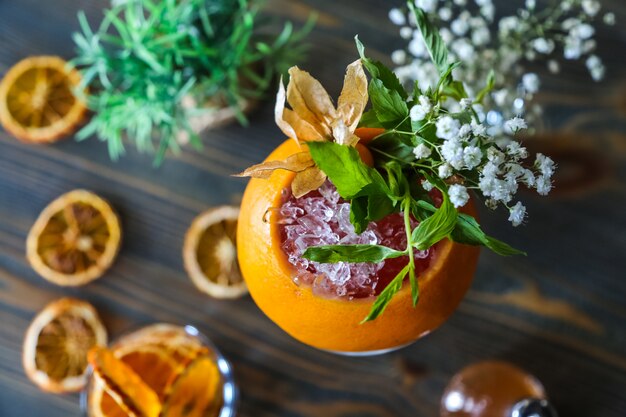 Grapefruit cocktails ice sparkling water mint syrop flowers top view