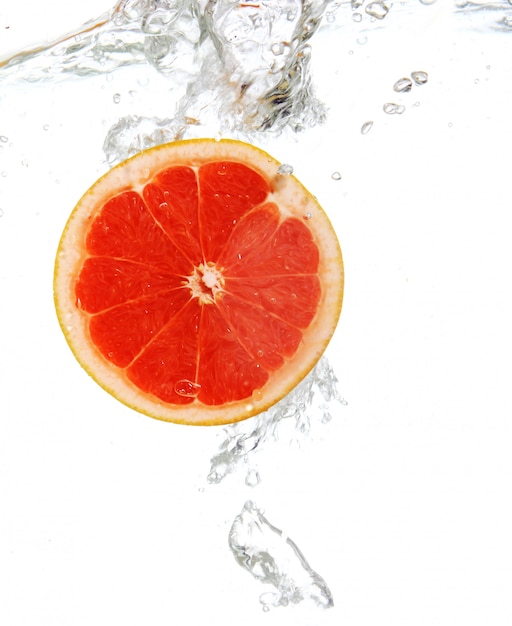 Grapefruit dropped into water