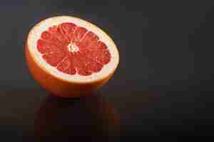 Free photo grapefruit isolated on a black. seasonal fruit