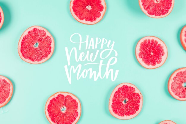 Grapefruit slices arrangement with happy new month lettering